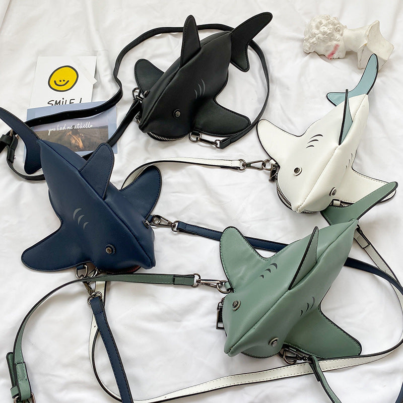 Four shark crossbody bags in black, white, navy and sage green
