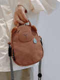 Brown canvas capybara phone bag with plush ears and blue teardrop, front view