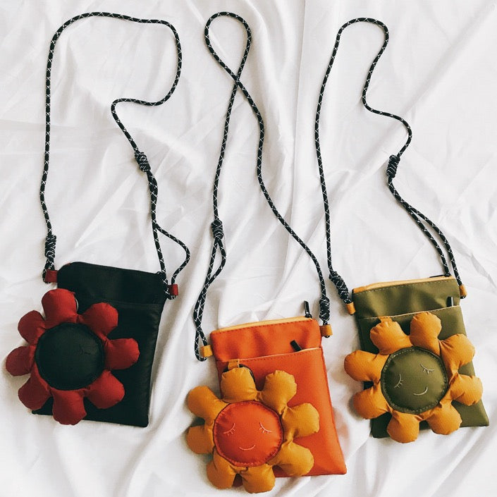 Three sunflower crossbody phone bags in black, orange and olive green