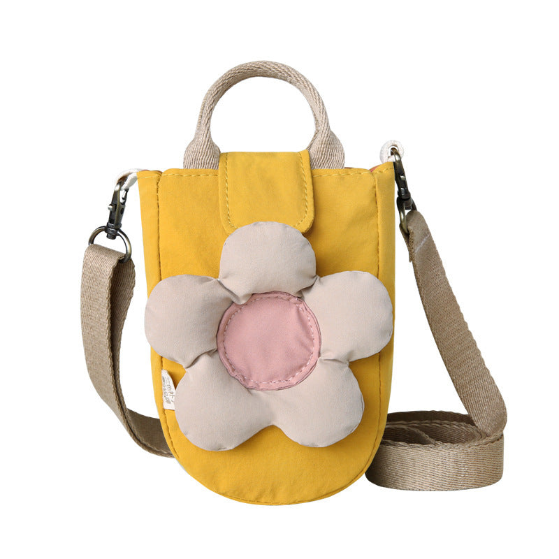 Mustard yellow crossbody phone bag with a puffy cream flower, front view