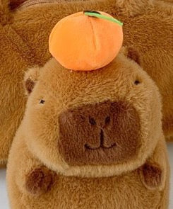 3D plush capybara crossbody bag with a tangerine on its head