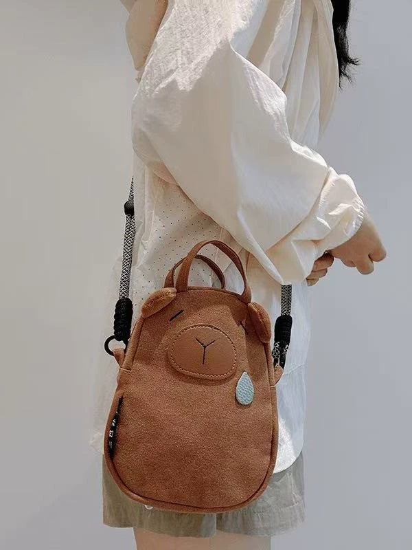 Capybara canvas bag worn crossbody at the hip