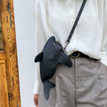 Black shark crossbody bag worn at the hip