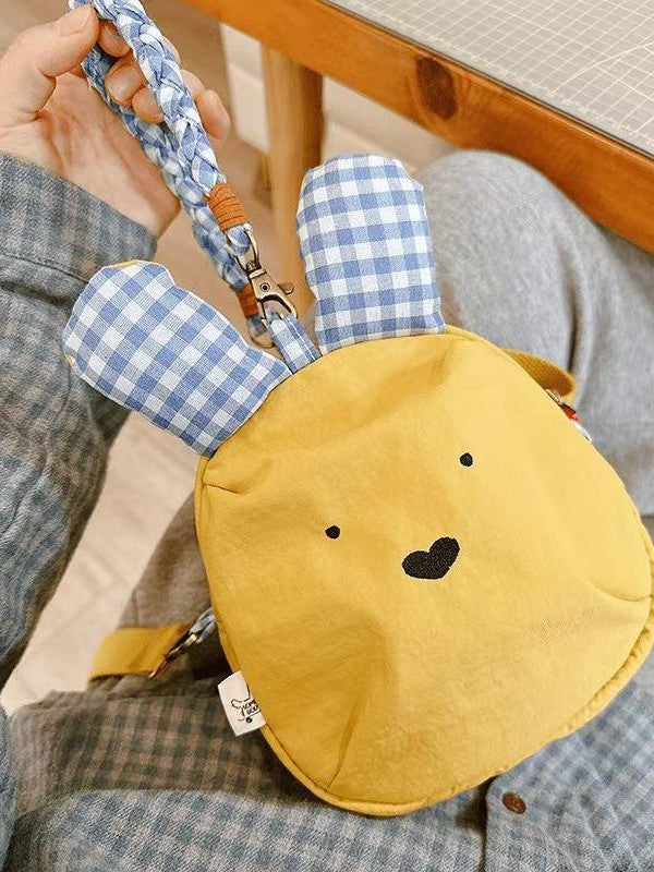 Yellow bunny bag front view with gingham ears and braided wrist handle