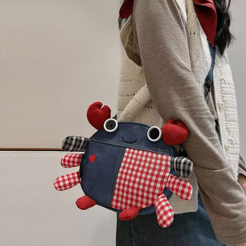 Denim crab bag worn at the hip, side view