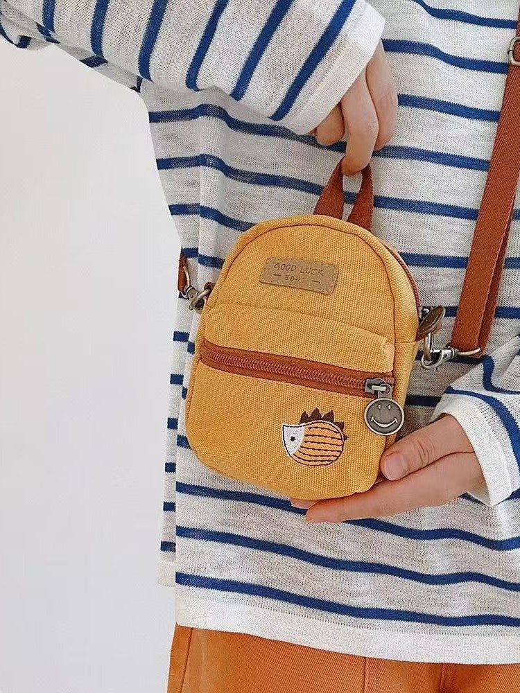 Hedgehog canvas mini bag held in two hands for scale