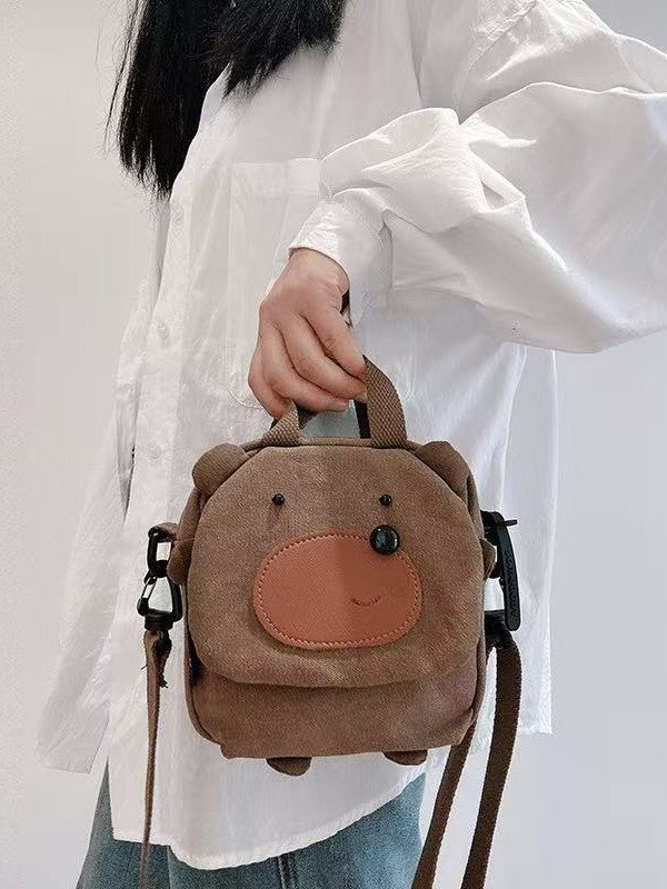 Bear bag carried by hand with the strap clipped on