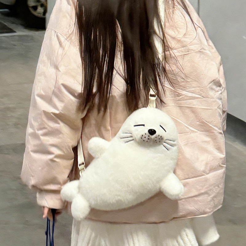 Cream white seal bag worn across the back