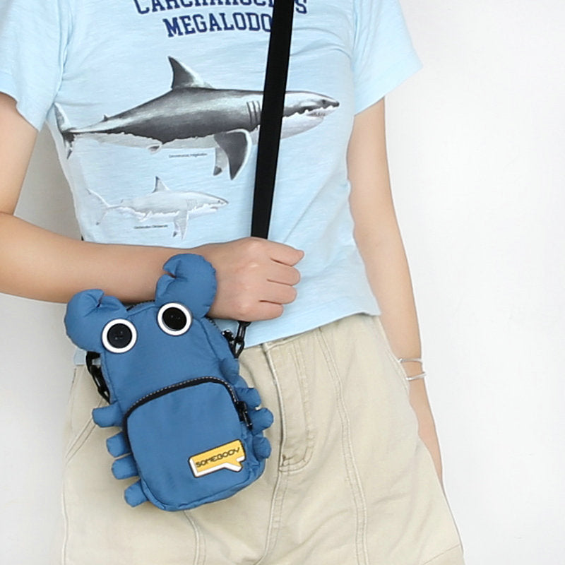 Denim blue crab phone bag worn crossbody