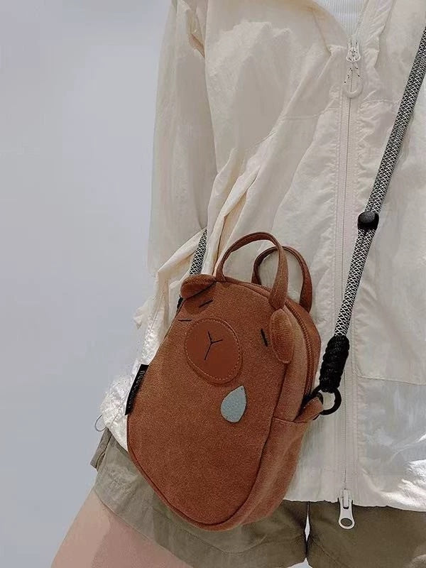 Side view of the capybara bag showing the zip and strap toggle