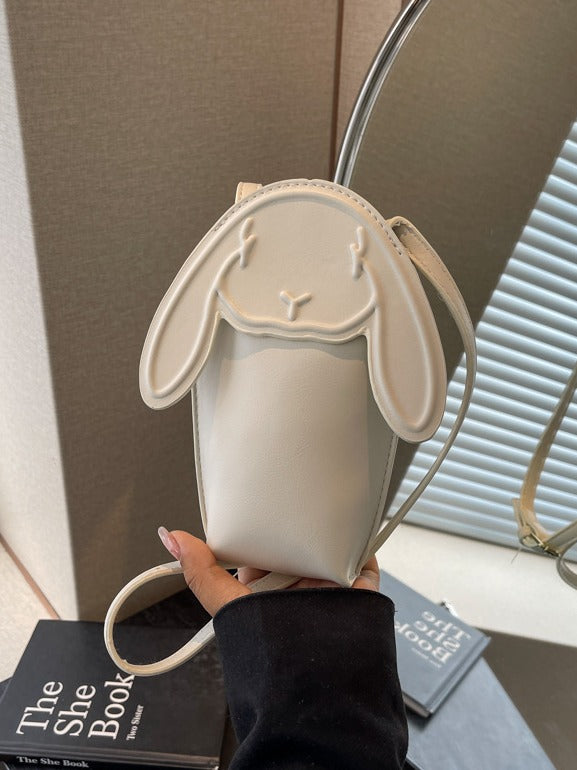 Cream bunny phone bag resting on a palm
