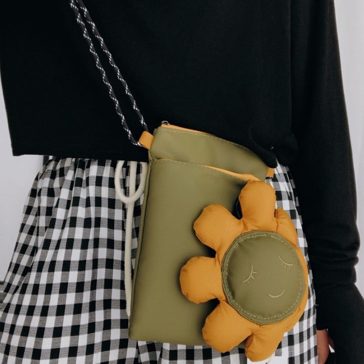 Olive green sunflower bag worn crossbody at the hip