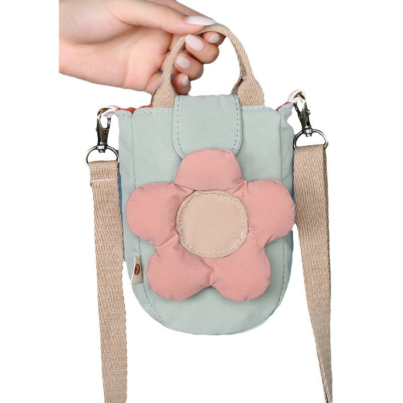 Mint green flower bag held by its top handle