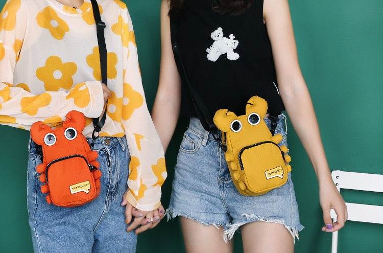 Orange and yellow crab bags worn side by side