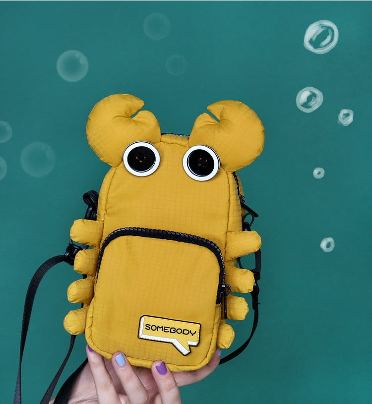 Yellow crab bag front view against teal background